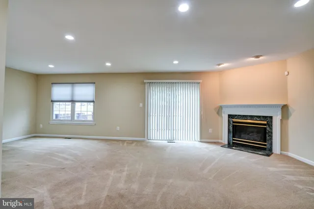 a view of empty room with a fireplace