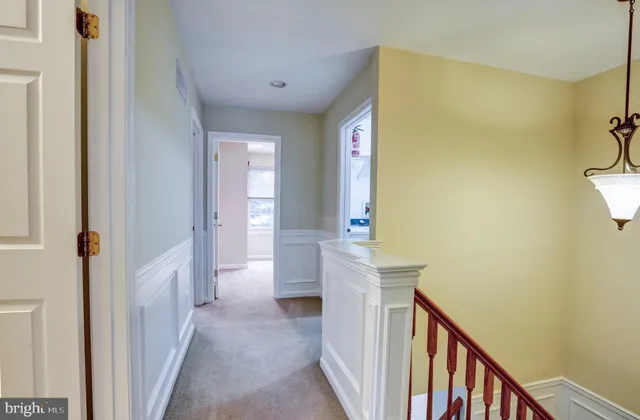 a view of a hallway with furniture