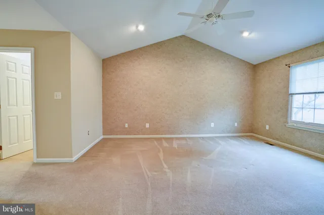 an empty room with windows and closet