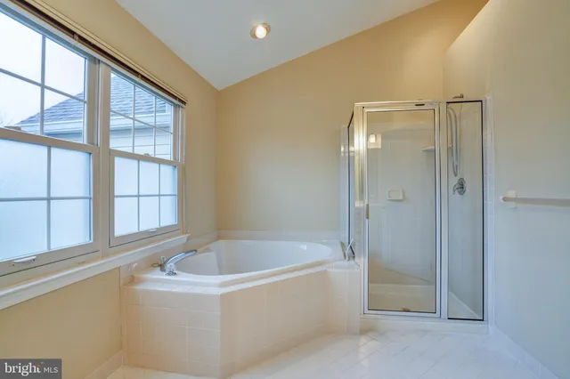a bathroom with a bathtub and a shower