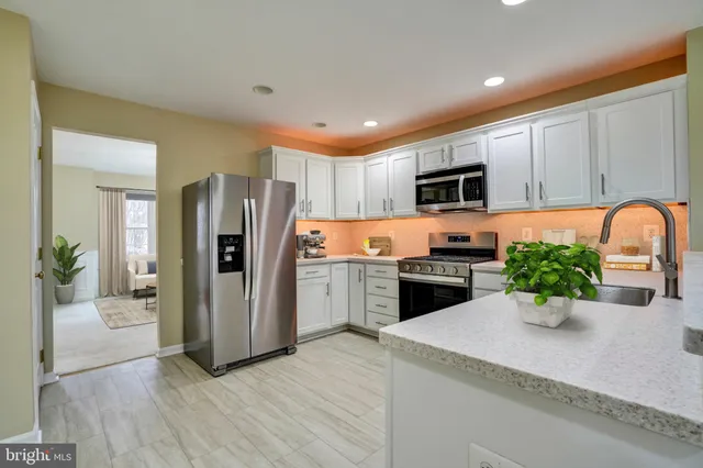 a kitchen with a refrigerator and a sink