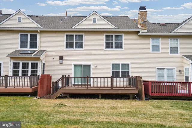a view of a house with a yard and sitting area