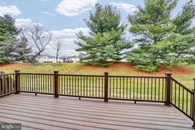 a wooden bench sitting in the middle of a yard