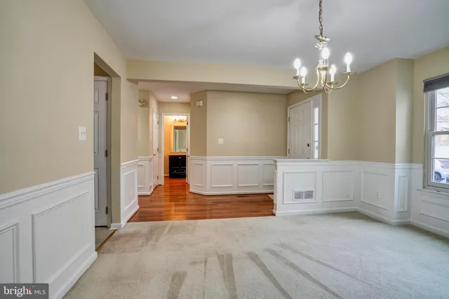 a view of a hallway with granite countertop a chandelier