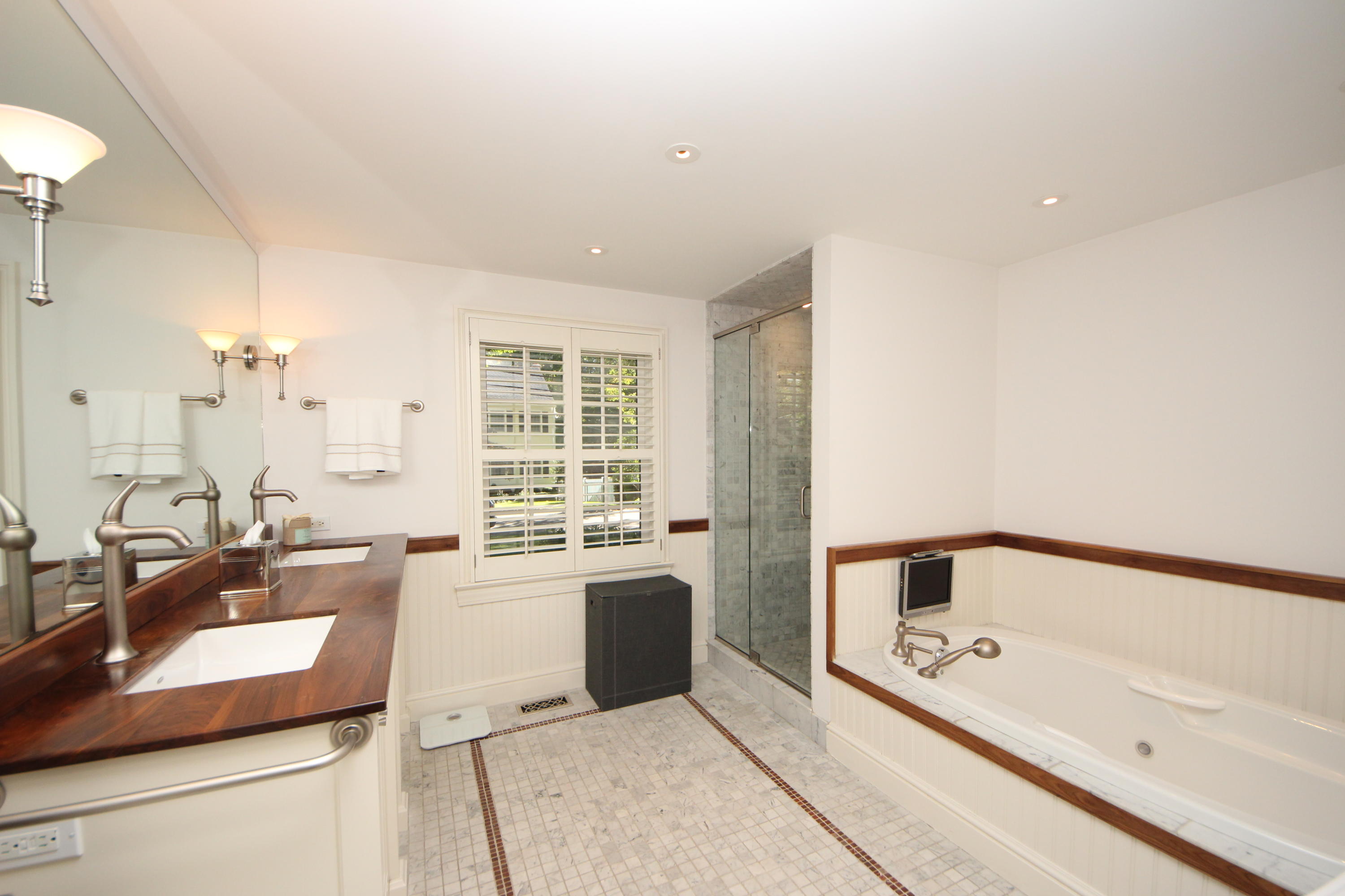 33 Intervale Road Darien, CT 06820 - Photo 15 of 28 a large bathroom with a tub a sink and a large mirror