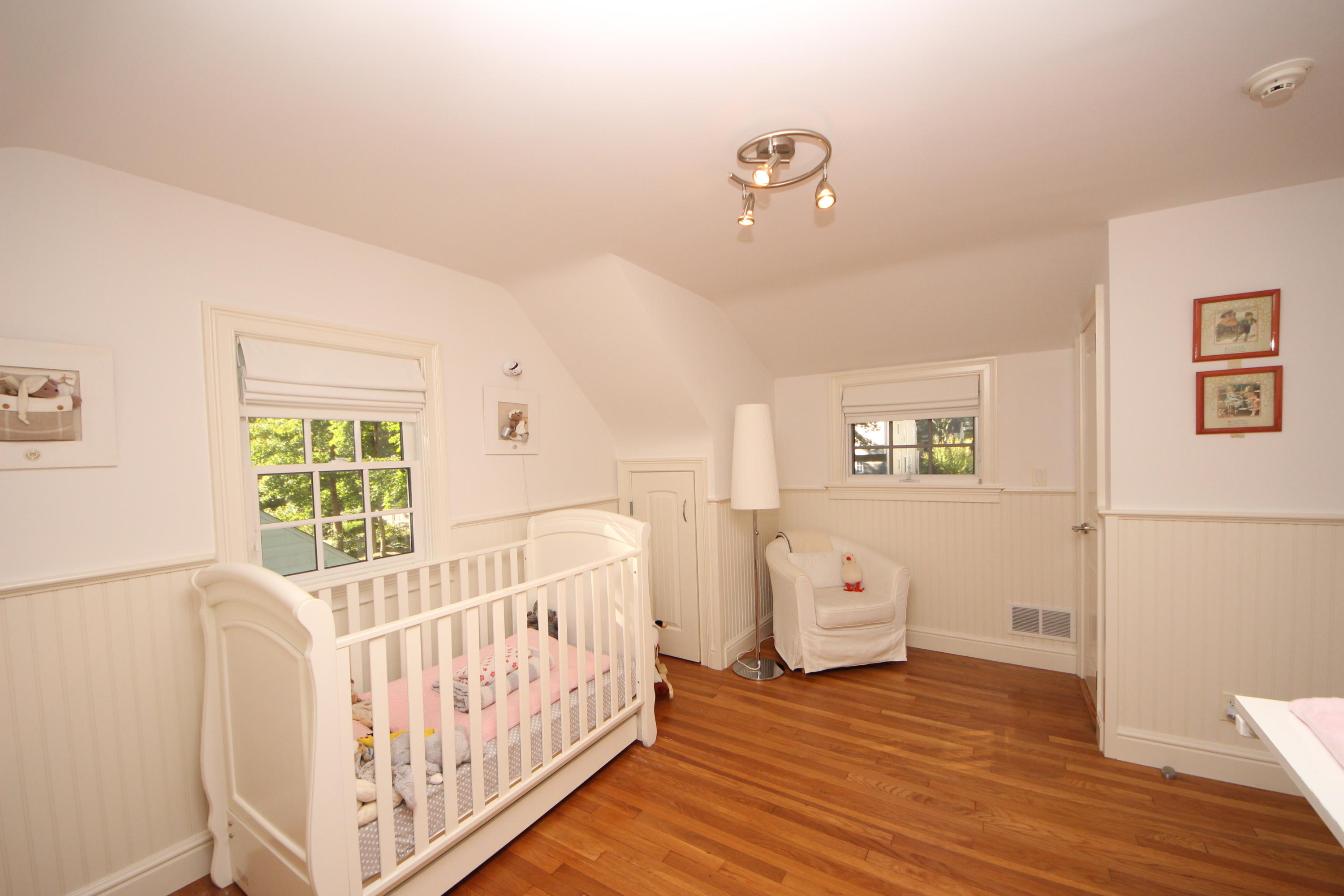 33 Intervale Road Darien, CT 06820 - Photo 19 of 28 a view of a bedroom with wooden floor & windows