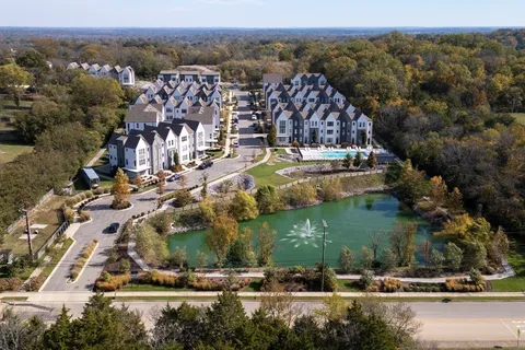 an aerial view of residential building with trees