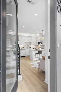 a living room with stainless steel appliances kitchen island granite countertop furniture and a view of living room
