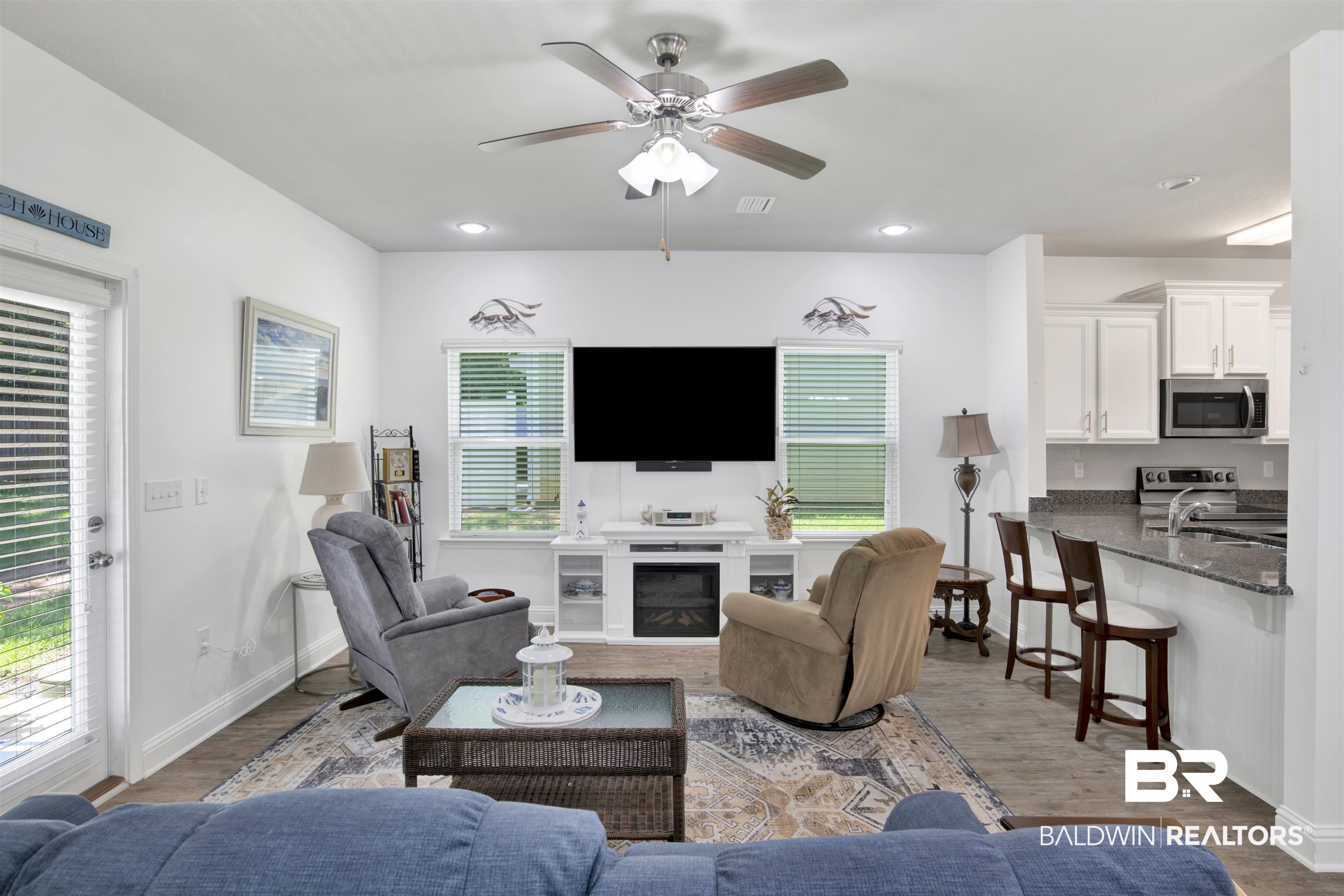 25806 Pollard Road, Unit 20 Daphne, AL 36526 - Photo 8 of 29 Living room featuring hardwood / wood-style flooring, sink, a fireplace, and ceiling fan