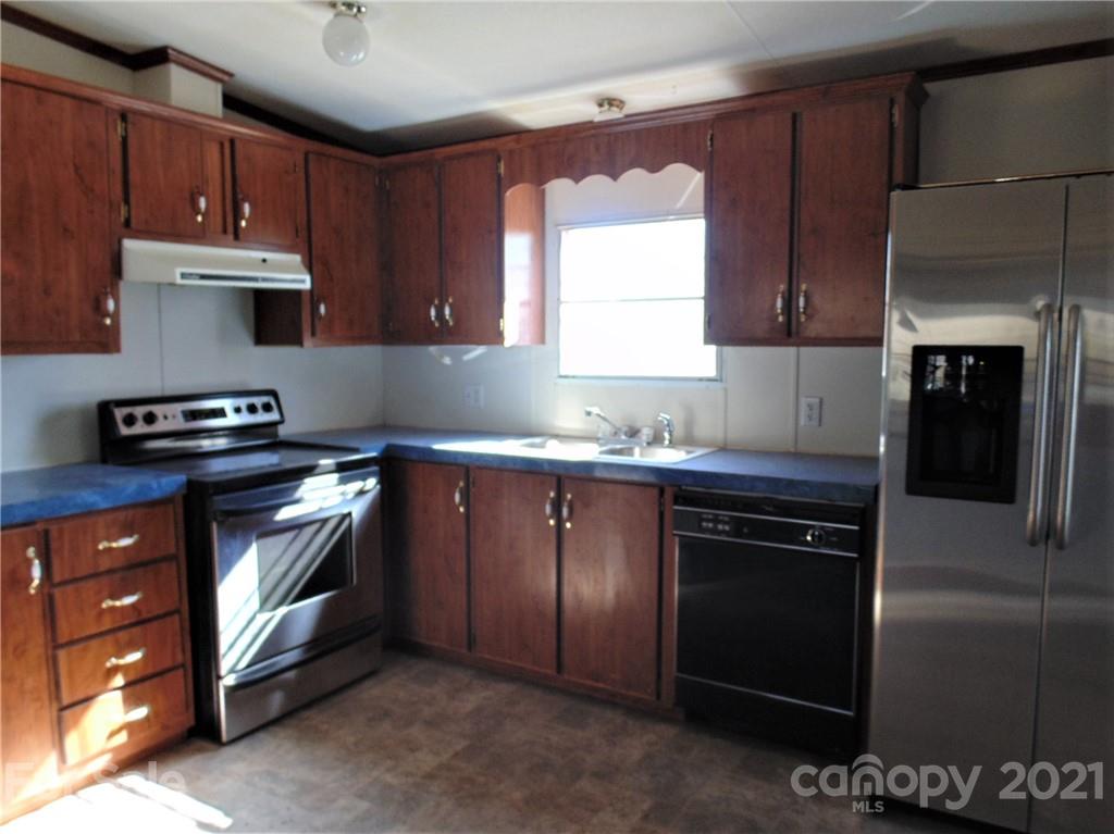 4335 Willis Hollis Road Edgemoor, SC 29712 - Photo 2 of 26 a kitchen with stainless steel appliances granite countertop a stove a sink and a microwave