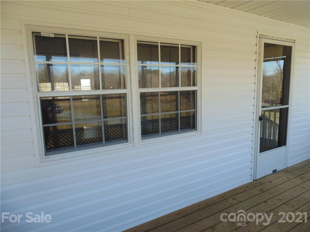 4335 Willis Hollis Road Edgemoor, SC 29712 - Photo 16 of 26 a view of empty room with wooden floor and windows