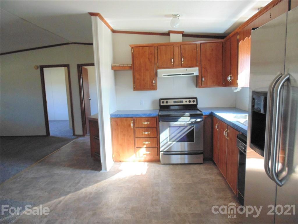 4335 Willis Hollis Road Edgemoor, SC 29712 - Photo 3 of 26 a kitchen with stainless steel appliances granite countertop a stove a refrigerator and a sink