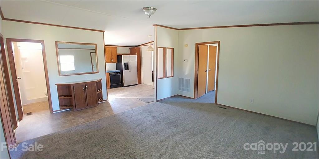 4335 Willis Hollis Road Edgemoor, SC 29712 - Photo 4 of 26 an empty room with a cabinet and mirrors