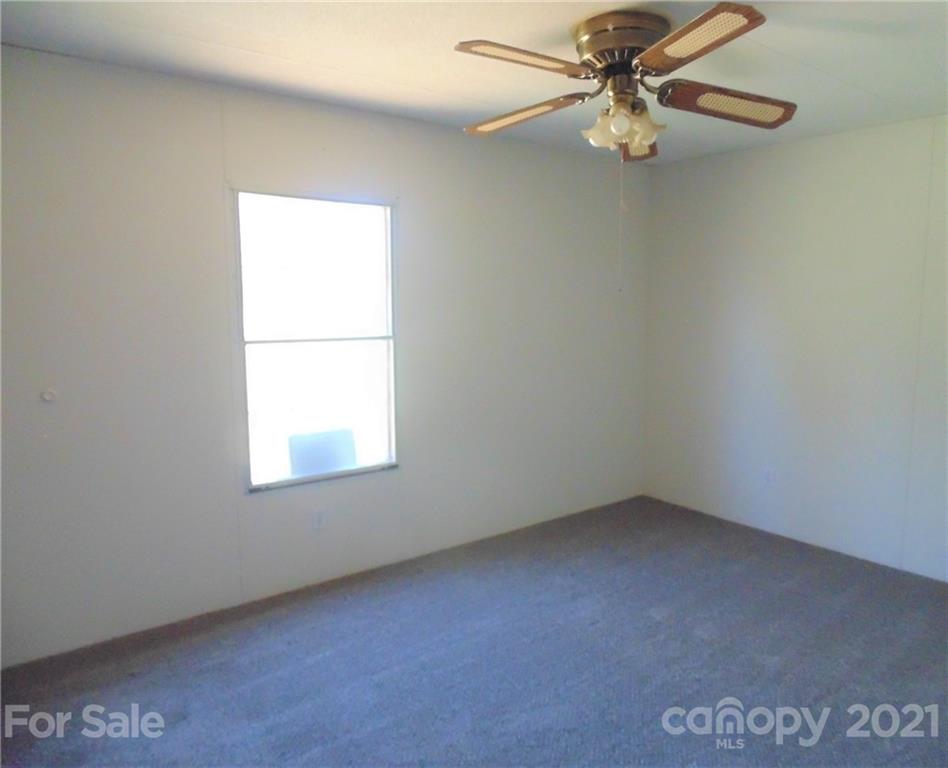 4335 Willis Hollis Road Edgemoor, SC 29712 - Photo 8 of 26 an empty room with a window and a fan