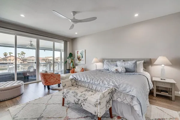 a spacious bedroom with a bed and a large window