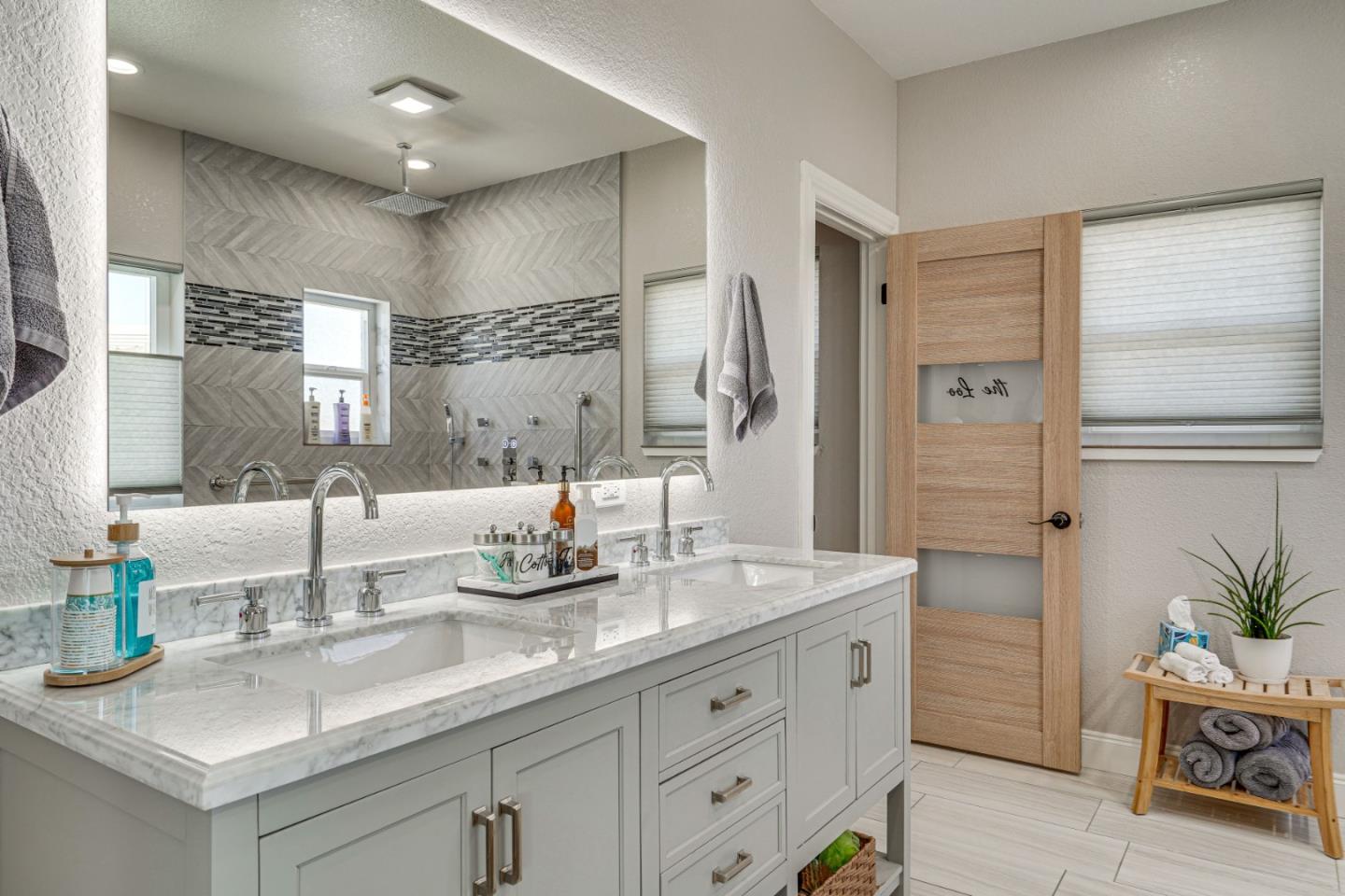 1944 Windward Point Discovery Bay, CA 94505 - Photo 15 of 43 a bathroom with a granite countertop sink a large mirror and shower