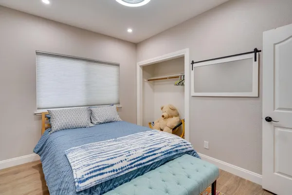 a bedroom with a bed and a window