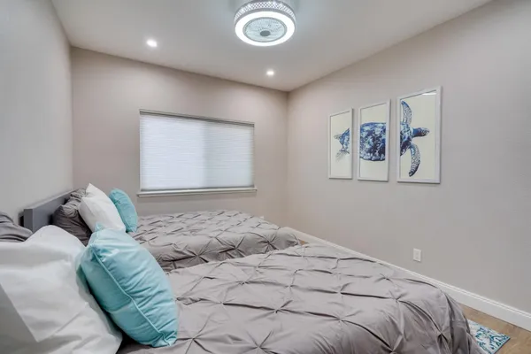 a bedroom with a bed and a painting on the wall