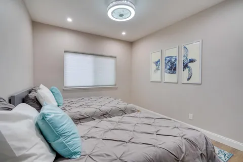 a bedroom with a bed and a painting on the wall