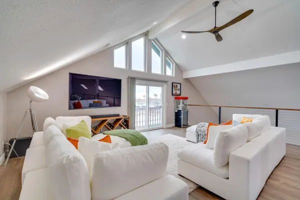 a bedroom with furniture and a flat screen tv