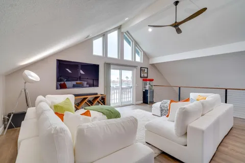 a bedroom with furniture and a flat screen tv