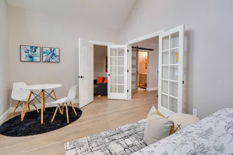 a bedroom with furniture and a window