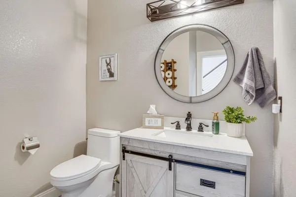 a bathroom with a toilet a sink and a mirror