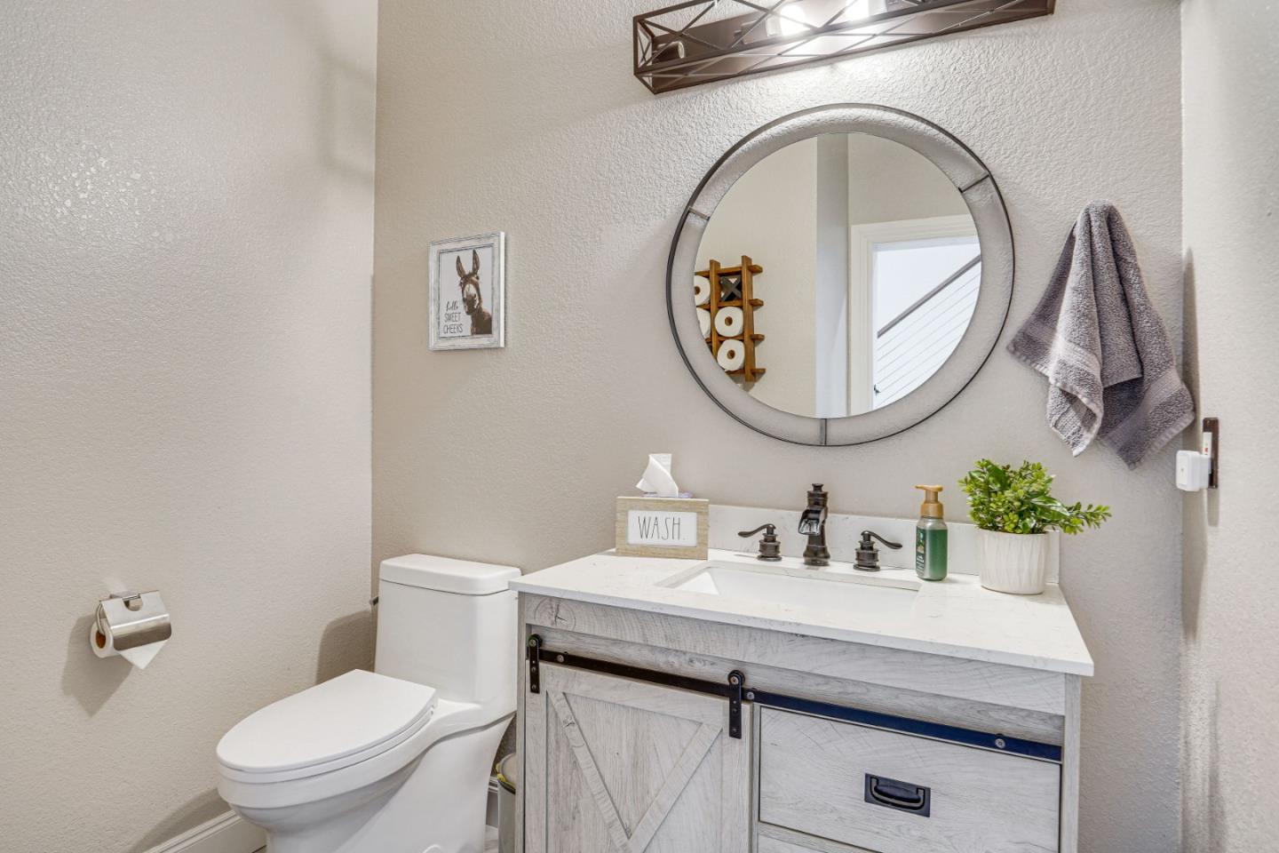 1944 Windward Point Discovery Bay, CA 94505 - Photo 39 of 43 a bathroom with a toilet a sink and a mirror