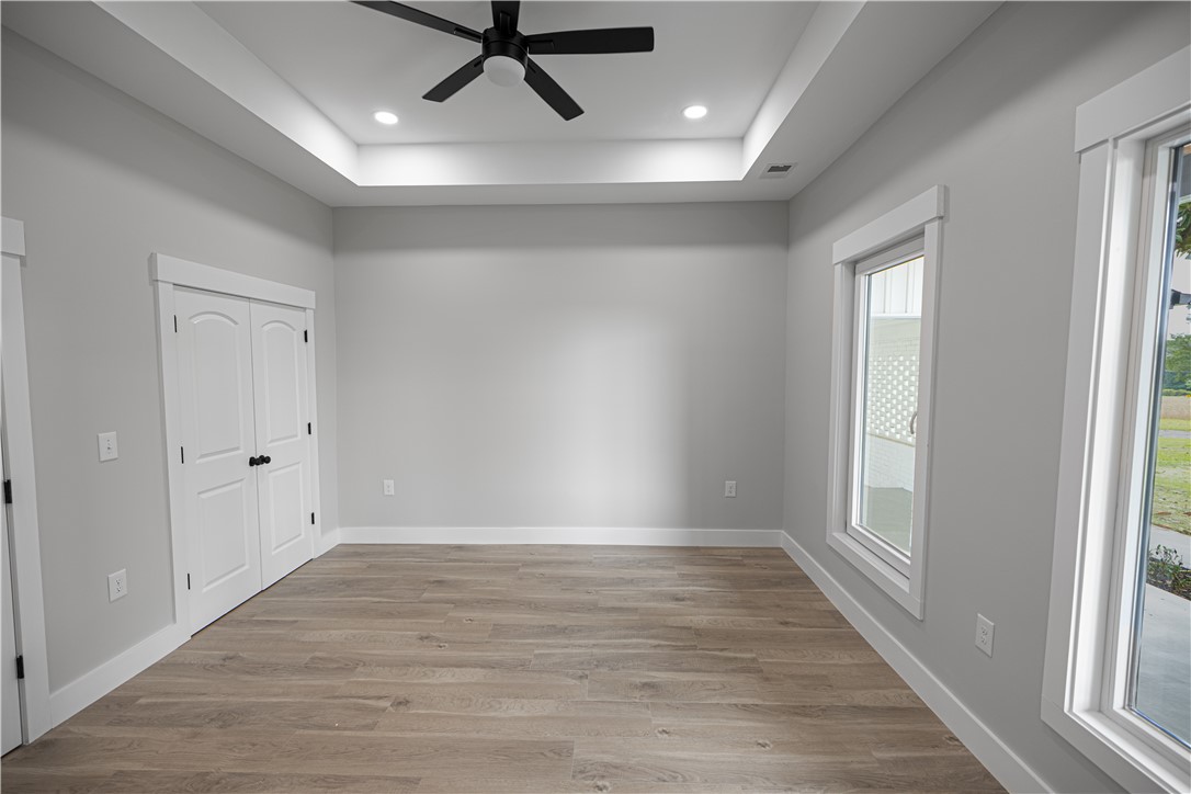 2817 Broadway Lake Road Anderson, SC 29621 - Photo 32 of 41 A well-lit room featuring a tray ceiling, recessed lighting, and durable wood flooring.