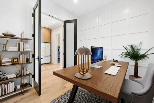 a view of a dining room with furniture and a potted plant