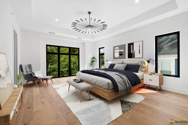 a spacious bedroom with a bed couch and a large window