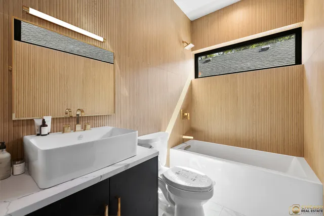 a bathroom with a sink a mirror and a toilet