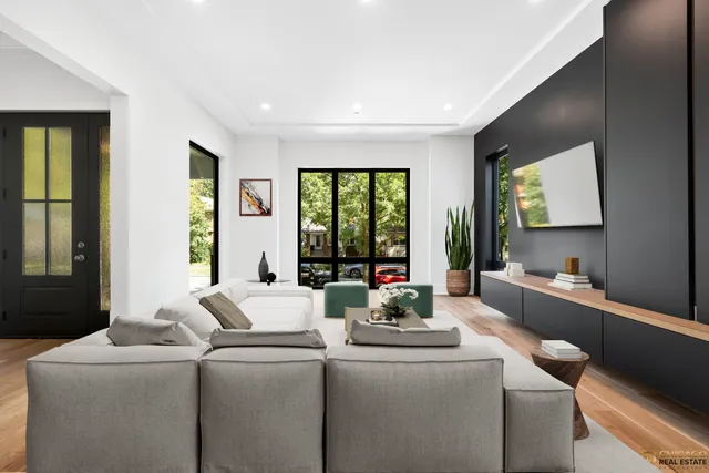 a living room with furniture and large windows