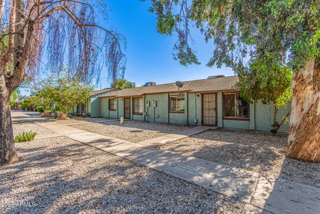 a view of a house with a yard and tree s