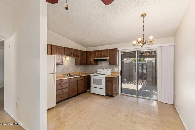 a kitchen with refrigerator and window