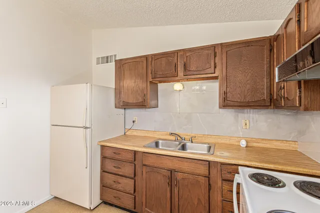 a kitchen with a sink cabinets and stainless steel appliances