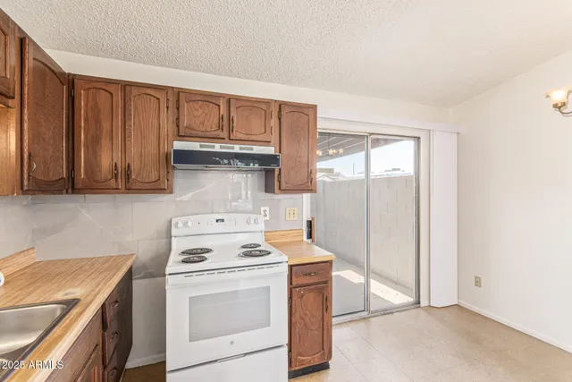a kitchen with a stove cabinets and a refrigerator