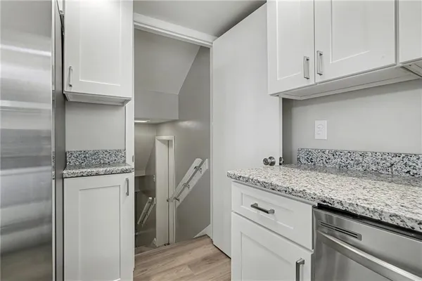 a kitchen with stainless steel appliances granite countertop a sink and a refrigerator
