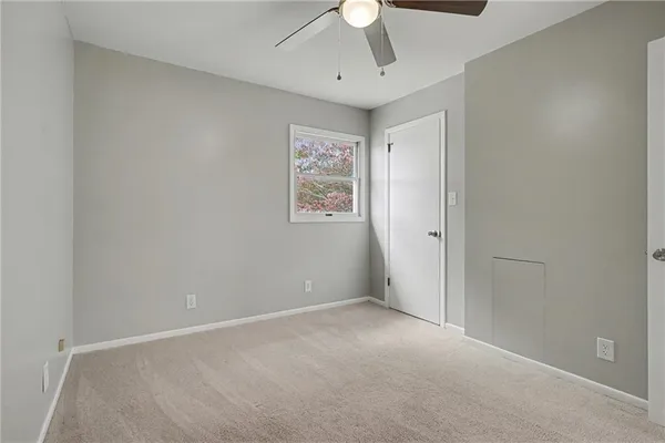 an empty room with windows and cabinet