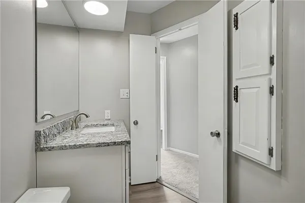 a bathroom with a granite countertop sink and a mirror