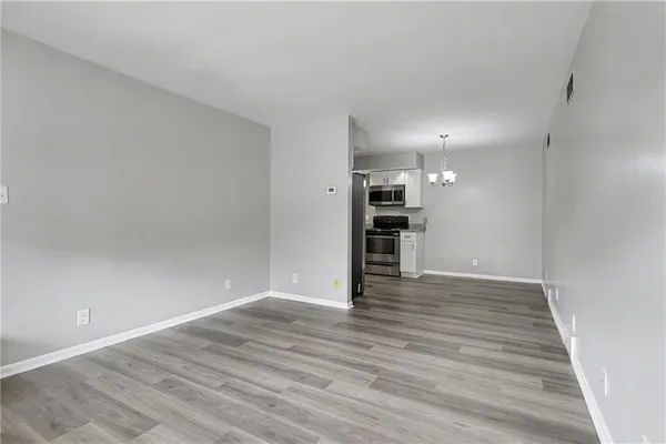 a view of empty room with wooden floor