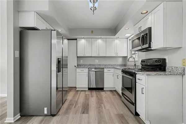 a kitchen with stainless steel appliances a refrigerator stove and sink
