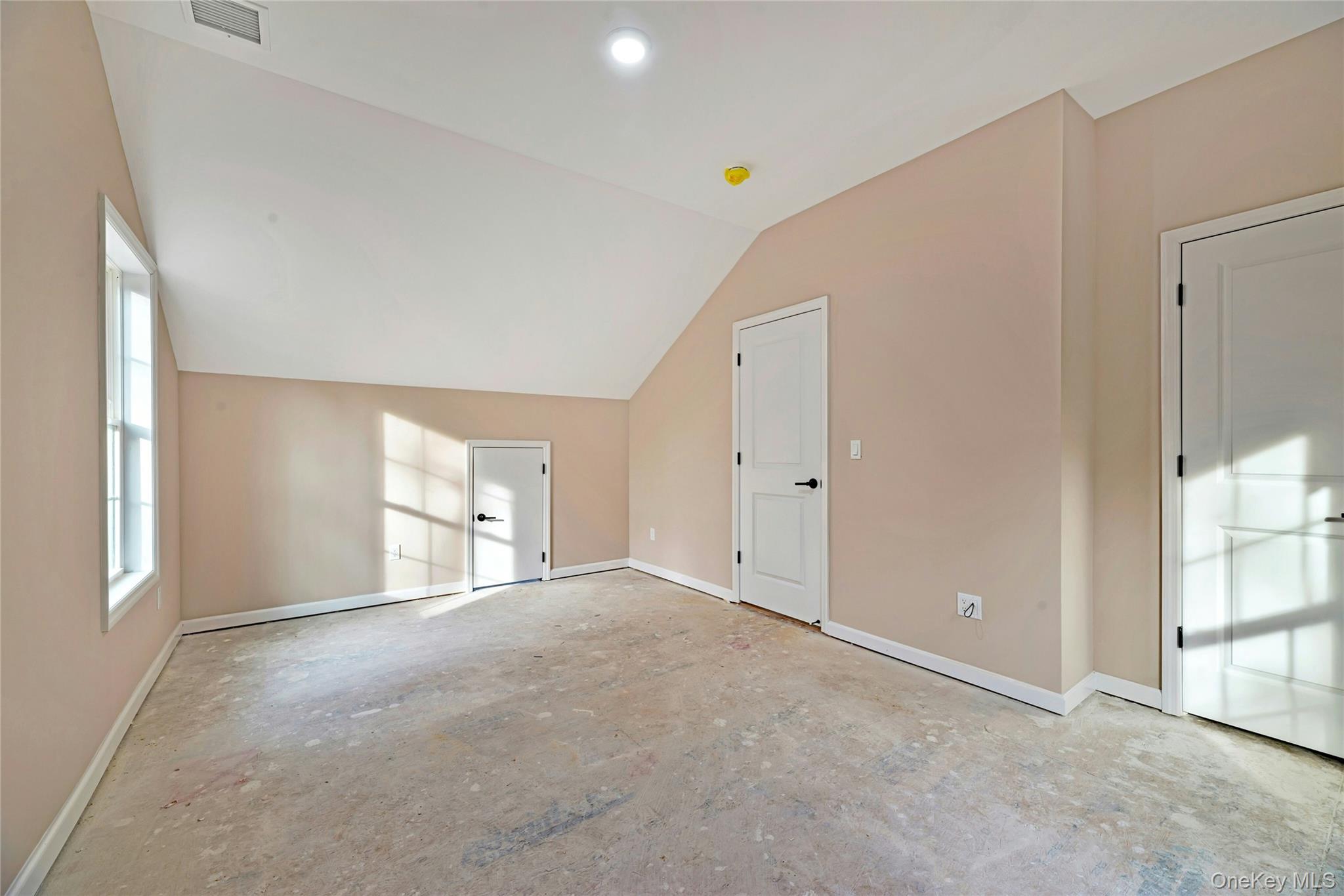 487 Neighborhood Road Shirley, NY 11967 - Photo 12 of 18 Additional living space featuring baseboards and vaulted ceiling