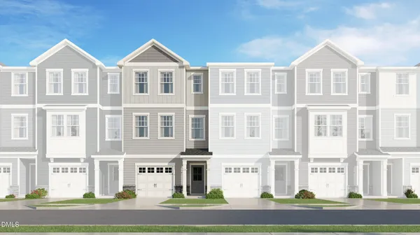 a front view of a residential apartment building with a yard