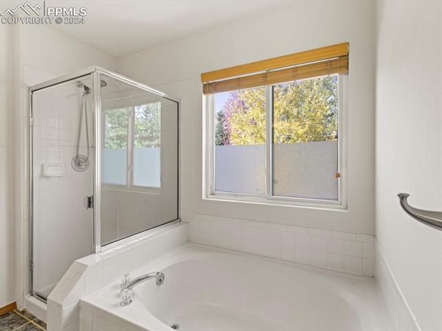 7590 Julynn Road Colorado Springs, CO 80919 - Photo 33 of 44 Bathroom featuring separate shower and tub