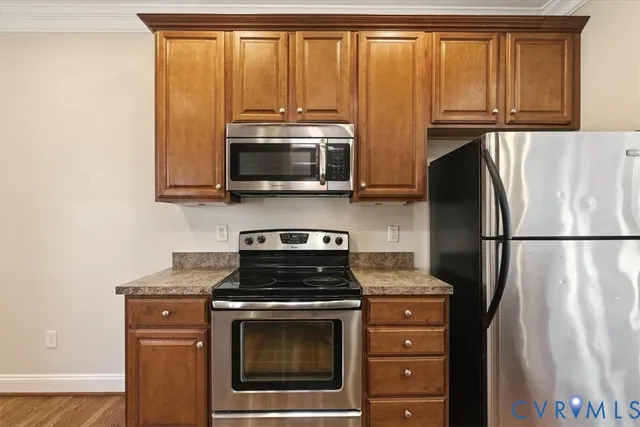 a kitchen with a refrigerator stove and microwave