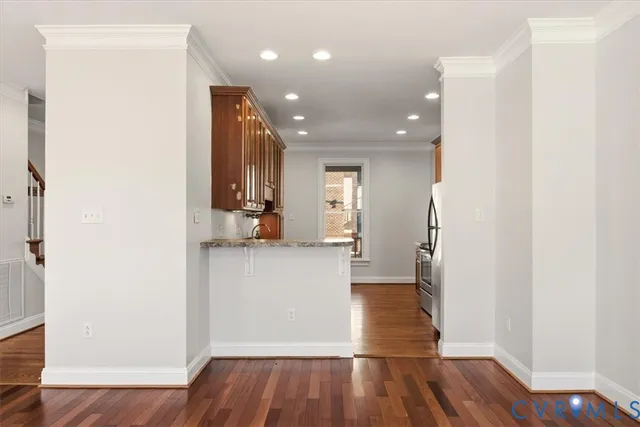 a view of empty room with wooden floor