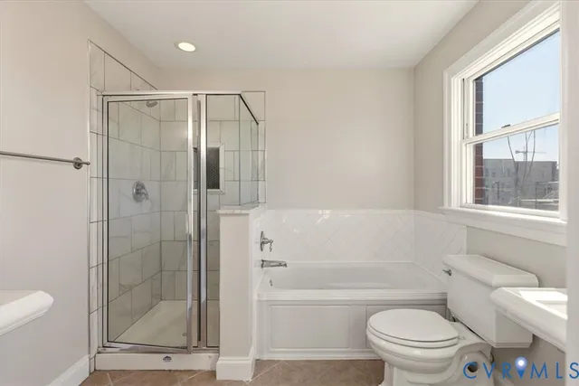 a bathroom with a shower a toilet and a bathtub