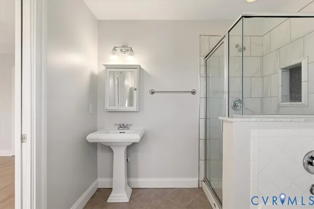 a bathroom with a sink a mirror and a shower