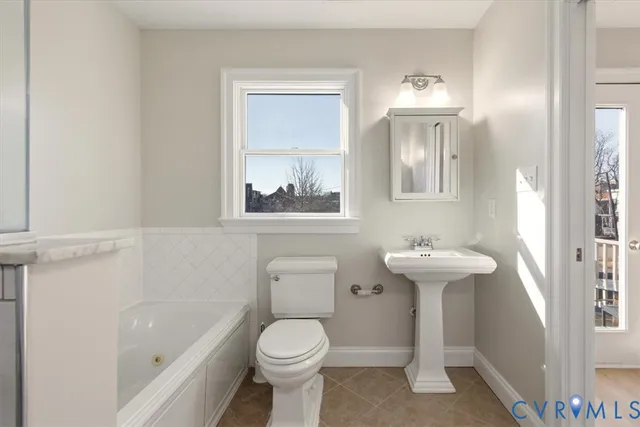 a bathroom with a sink a toilet and bathtub